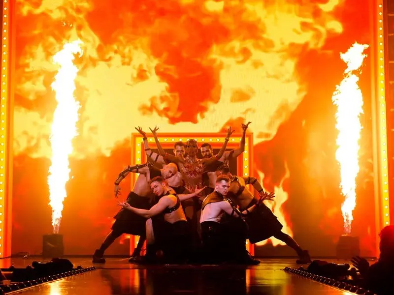 RuPaul's Drag Race LIVE! performer surrounded by fire and male dancers on the Flamingo stage
